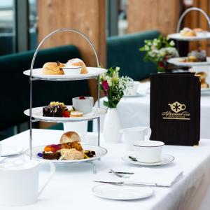 a table with three tiered plates of pastries and desserts at Ice House Hotel in Ballina