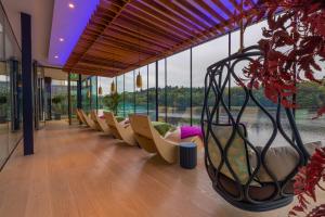 a row of chairs in a building with windows at Ice House Hotel in Ballina