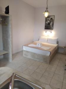 a bedroom with a bed and a sink in it at amorgaia3 in Katapola