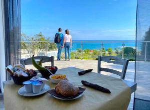 a table with food on it with a view of the ocean at Frontemare Hotel Village & Ristorante in Rodi Garganico