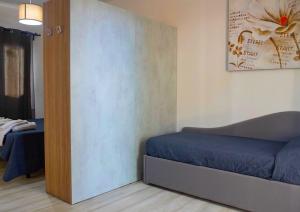 a small room with a bed and a wall at Frontemare Hotel Village & Ristorante in Rodi Garganico