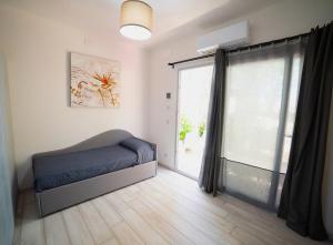 a bedroom with a bed and a large window at Frontemare Hotel Village & Ristorante in Rodi Garganico