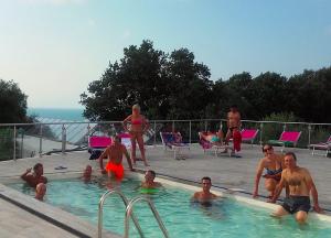 a group of people in a swimming pool at Frontemare Hotel Village & Ristorante in Rodi Garganico