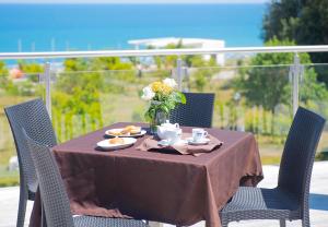 a table with food and a vase of flowers on it at Frontemare Hotel Village & Ristorante in Rodi Garganico