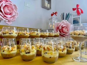 a bunch of cups filled with food in them at Frontemare Hotel Village & Ristorante in Rodi Garganico