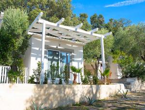 a white pergola on top of a house at Frontemare Hotel Village & Ristorante in Rodi Garganico