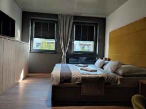 Posteľ alebo postele v izbe v ubytovaní OPÁL Residence Apartman