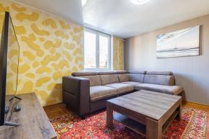 a living room with a couch and a coffee table at Kopų 32 Šventoji in Šventoji