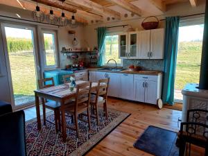 a kitchen with a table and chairs in a room at Dom Malarki in Mirosławiec