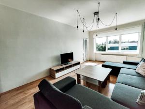 a living room with two couches and a tv at Suur-Sepa apartment near city centre and beach in Pärnu