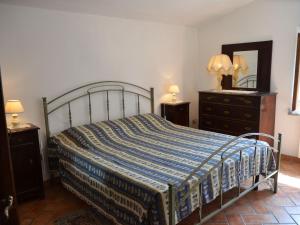 a bedroom with a bed and two dressers and a mirror at Charmante Home with Garden in San Valentino