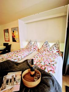 a bedroom with two beds with a bottle of wine at Sankt Moritz Spirit Piz Mezdi 15 in St. Moritz