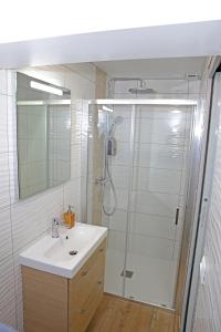 a bathroom with a shower and a sink and a mirror at #Sweet Dreams By Nogar'Homes - WiFi-Netflix-Climatisation in Nogaro