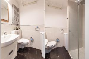 a bathroom with two toilets and a sink and a shower at SuperApart Mokotowska 67 in Warsaw