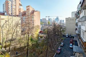 a view of a city street with cars parked at 1 комн Саксаганского17 Центр Олимпийская Дворец Спорта in Kyiv