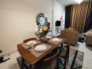 a dining room table and chairs in a living room at Ammar @ Troika in Kota Bharu