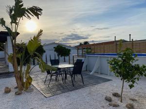 a patio with a table and chairs in a backyard at Casa Mama in Alhaurín el Grande