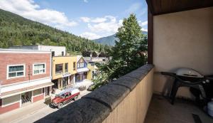 a view of a city from a balcony of a building at Lux Downtown Condo by Revelstoke Vacations in Revelstoke