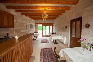 a large room with a kitchen and a dining room at Narcissos Cave Hotel in Urgup