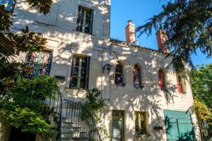 an old white building with red windows and stairs at Clos du Bois Brard B&B in Saumur