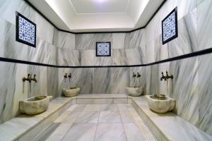 a bathroom with three sinks in a wall at Pera Rose Hotel - Taksim Pera in Istanbul
