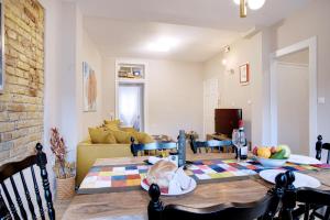 a living room with a table and a couch at Cheerful apartment in the heart of Corfu Old Town in Corfu