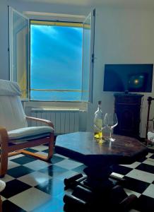 a living room with a table and two wine glasses at La Lampara Camogli in Camogli