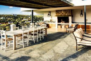 a kitchen and dining room with a table and chairs at Oudewerfskloof Olive Farm in Stilbaai