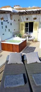 a balcony with two pillows and a swimming pool at Sea Side Studios & Houses in Kalo Livadi