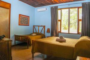 Postel nebo postele na pokoji v ubytování Hotel Boruca Tamarindo + 37 fotografií