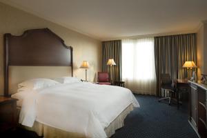a hotel room with a large bed and a window at Barceló San Salvador in San Salvador +19 photos