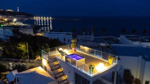a building with lights on top of it at night at Le Pativite Luxury Apartments by HDSalento in Leuca
