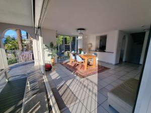 a living room with a table and a dining room at Wohlfühl-Oase mit Traumblick für alle Generationen inkl Aufzug in Gambarogno