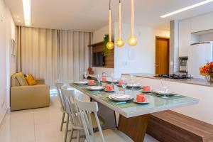 a kitchen and living room with a table and chairs at Solar Porto Rico in Porto De Galinhas