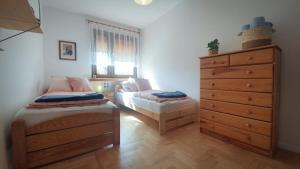 sypialnia z 2 łóżkami pojedynczymi i komodą w obiekcie JLS Apartament z parkingiem przy plaży w Gdańsku