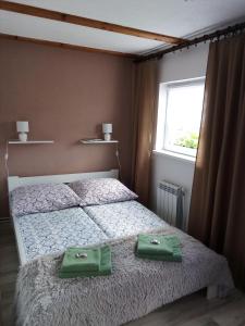a bedroom with a bed with two green bags on it at Domek na Prerii in Ustrzyki Dolne