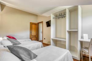 Łóżko lub łóżka w pokoju w obiekcie Hotel Villa De Santis