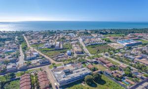 an aerial view of a city next to the ocean at Orquídeas Praia Hotel in Porto Seguro