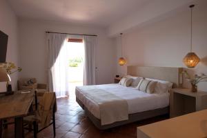 a bedroom with a white bed and white walls at Can Arabí in Ibiza Town