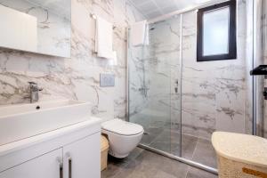 a bathroom with a shower and a toilet and a sink at Golden Rose Suit pension in Kaş