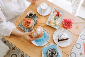 a table topped with plates of food and desserts at Dimora Anderì in Polignano a Mare
