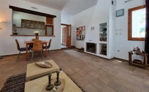 a living room with a table and a fireplace at Casa Biank in Rodalquilar