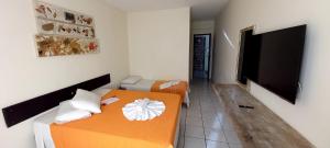 Tempat tidur dalam kamar di Hotel Recanto Do Sol