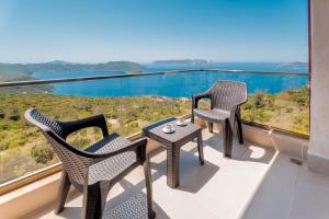 two chairs and a table on a balcony with a view at Golden Rose Suit pension in Kaş