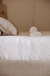 a white bed with two pillows on top of it at Dimora Anderì in Polignano a Mare