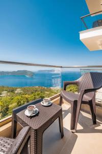 a balcony with two chairs and a table with two cups at Golden Rose Suit pension in Kaş