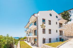 a white apartment building with a view of the ocean at Golden Rose Suit pension in Kaş