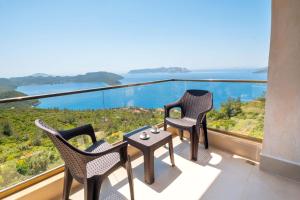 two chairs and a table on a balcony with a view at Golden Rose Suit pension in Kaş