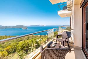 a balcony with chairs and a view of the ocean at Golden Rose Suit pension in Kaş