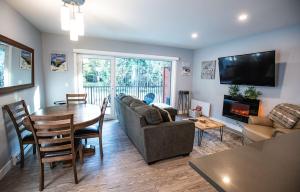 a living room with a table and a couch and a table and a table at Al's Escape by Revelstoke Vacations in Revelstoke